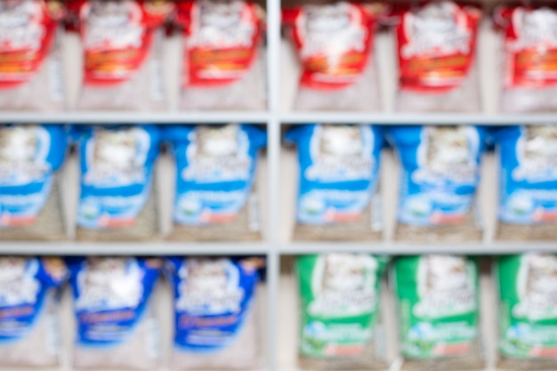 Close-up of various vitamin C supplements (pills, powders, effervescent tablets) with the label information clearly visible. Blurred background with a pharmacy shelf.