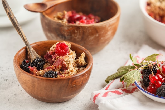 Close-up of a bowl of oatmeal topped with sliced fruit and a sprinkle of brown sugar, emphasizing a healthy breakfast.