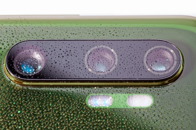 Close-up of a solar panel's surface on a cloudy day, showing tiny water droplets and dust particles. The image highlights the resilience and technology of the panels in non-ideal conditions.