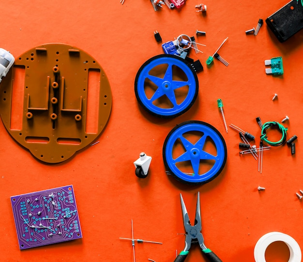 A close-up shot of various colorful robotic components neatly organized in a kit. The components include sensors, motors, wires, and microcontrollers, showcasing the versatility and potential of the robotics kit.