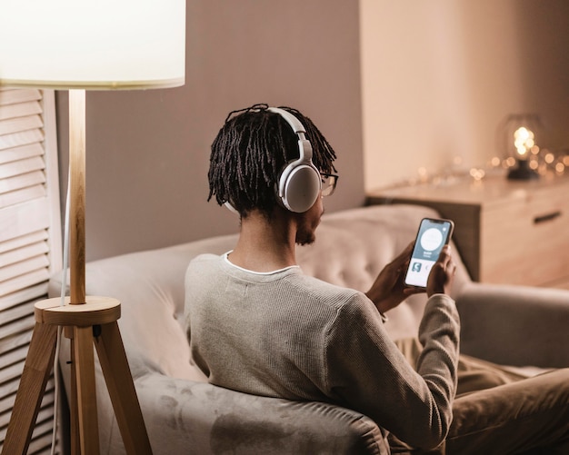 A lifestyle shot of a person wearing spatial audio headphones while watching a movie on a tablet, showing how the experience is enhanced by the technology, with a focus on the immersive nature of the sound and picture.