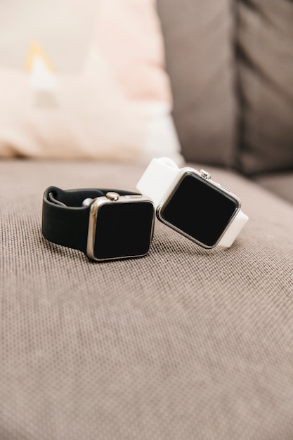 A side-by-side comparison shot featuring the Apple Watch Series 9 and the Samsung Galaxy Watch 6. Each watch should be displaying its respective home screen with clearly visible icons and complications.