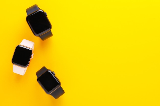 A visually appealing arrangement of three different smartwatches showcasing various price points: a budget-friendly Xiaomi Mi Band, a mid-range Fitbit Versa, and a premium Apple Watch Series 9. Each watch should be displayed with its price tag clearly visible.