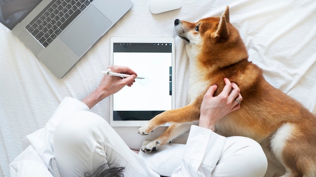 A veterinarian examining data from a pet wearable on a tablet, with a friendly dog looking on from the examination table. The scene should convey trust and advanced technology.