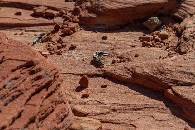 A close-up image of the Martian surface showing evidence of hydrated minerals, with a rover wheel track visible in the foreground.