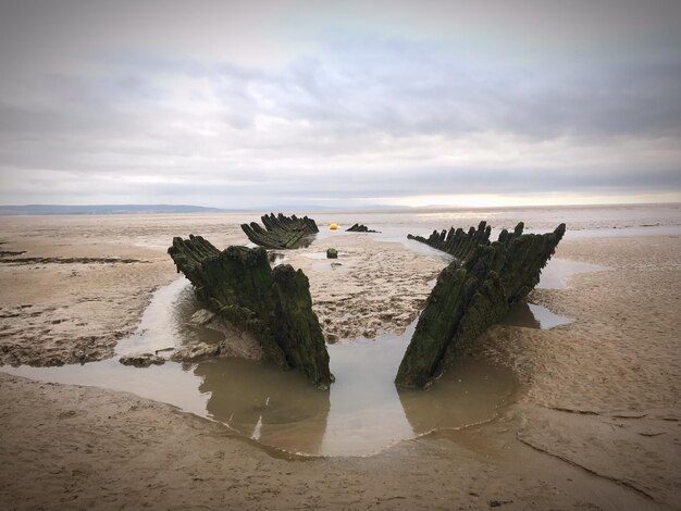 A side-by-side comparison of a coastline at high tide and low tide, highlighting the difference in water level and the exposed land.