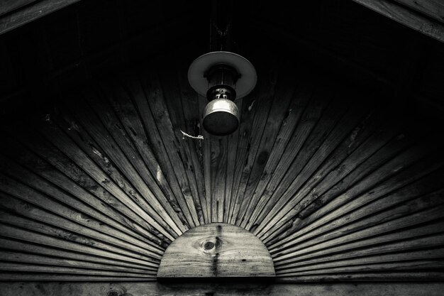 A dimly lit, dusty attic room. A single beam of light shines on an old wooden chest, slightly ajar, hinting at hidden secrets and the possible location where the Coroa do Brasil Diamond might be concealed.