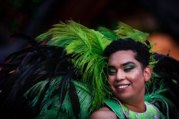 A color photograph taken during a samba school parade in Rio de Janeiro's Carnival. The dancers should be wearing elaborate, colorful costumes, and the floats should be extravagantly decorated. The crowd should be visible and cheering enthusiastically. The atmosphere should be vibrant and festive.