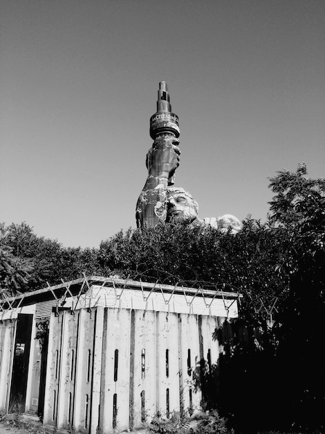 A black and white photograph of a historical monument to the Bandeirantes in São Paulo, Brazil. The monument should be depicted in its urban setting, with surrounding buildings and pedestrian activity in the background. The photo should capture the grandeur and the historical context of the monument.