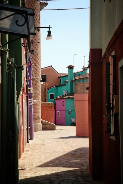 A colorful photo showing a bustling street in the Italian neighborhood of Bixiga in São Paulo, Brazil. The street is decorated with Italian flags, and people are enjoying traditional Italian food and music.